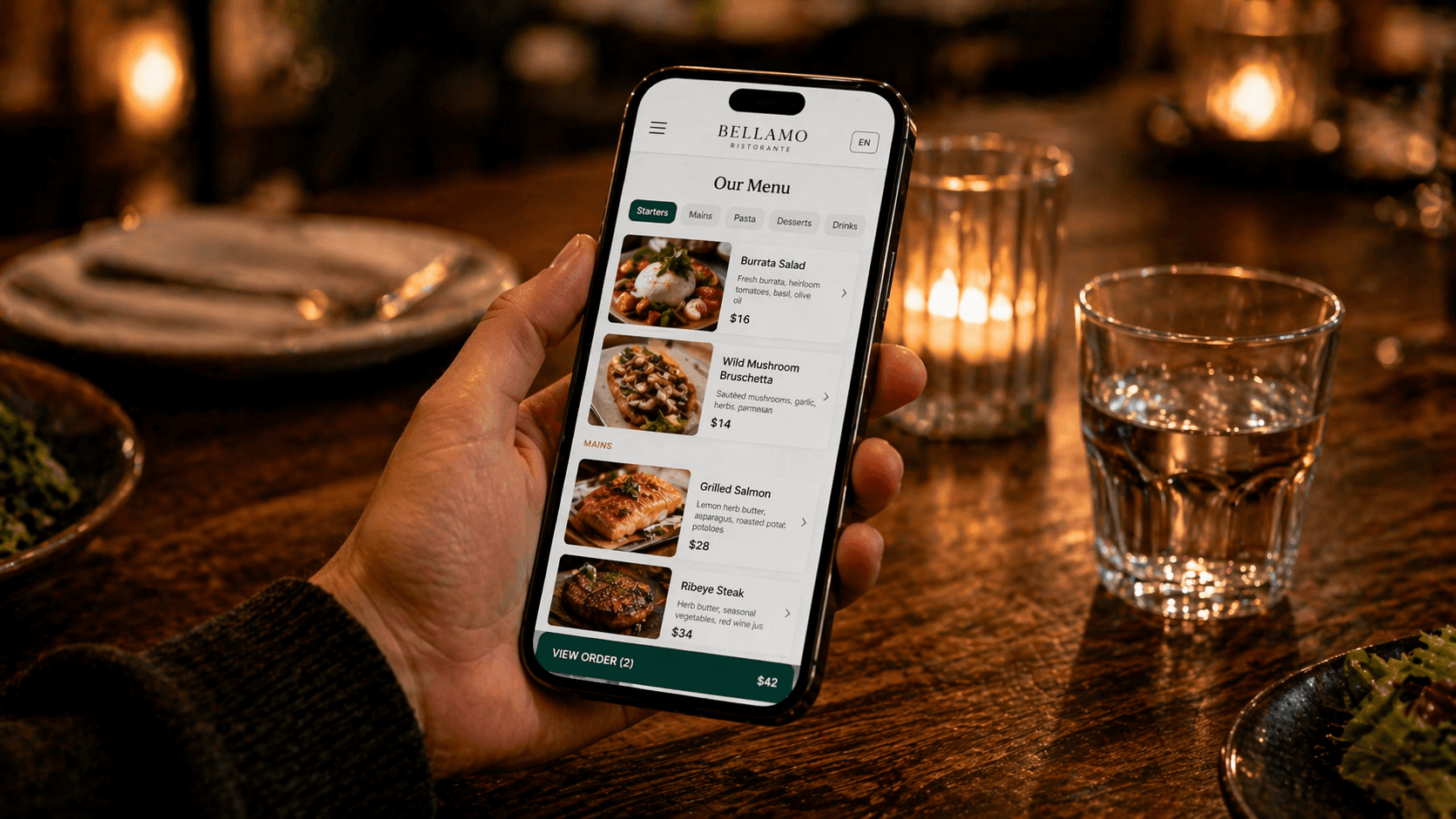 A guest viewing a colorful digital menu on a phone at a modern restaurant table